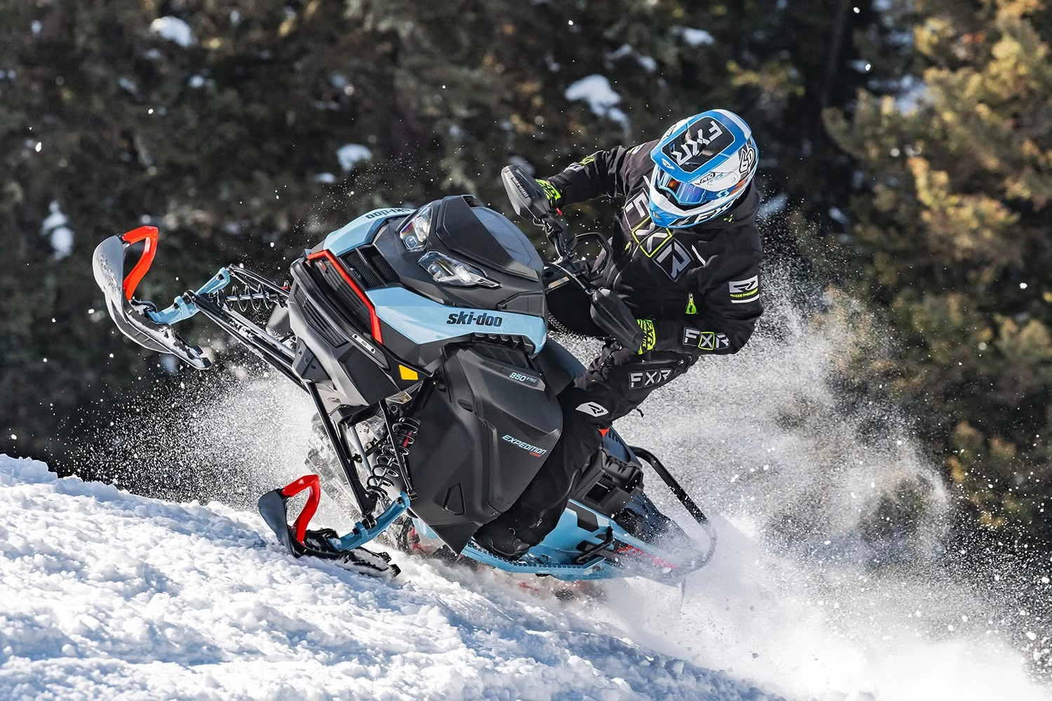 Snowmobile rider navigating snowy terrain.